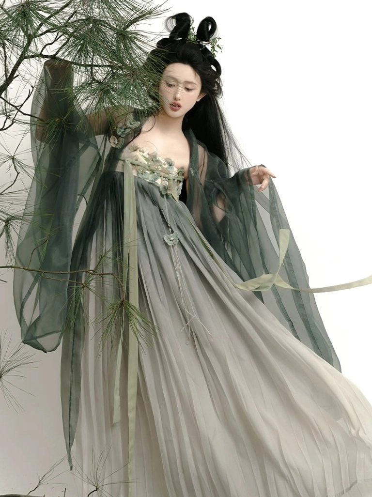 Dynamic low-angle side view of Mountain Mist Tang Dynasty Hanfu showing lightweight flowing chiffon fabric, detailed chest embroidery, wide sleeves, and trailing green silk sashes