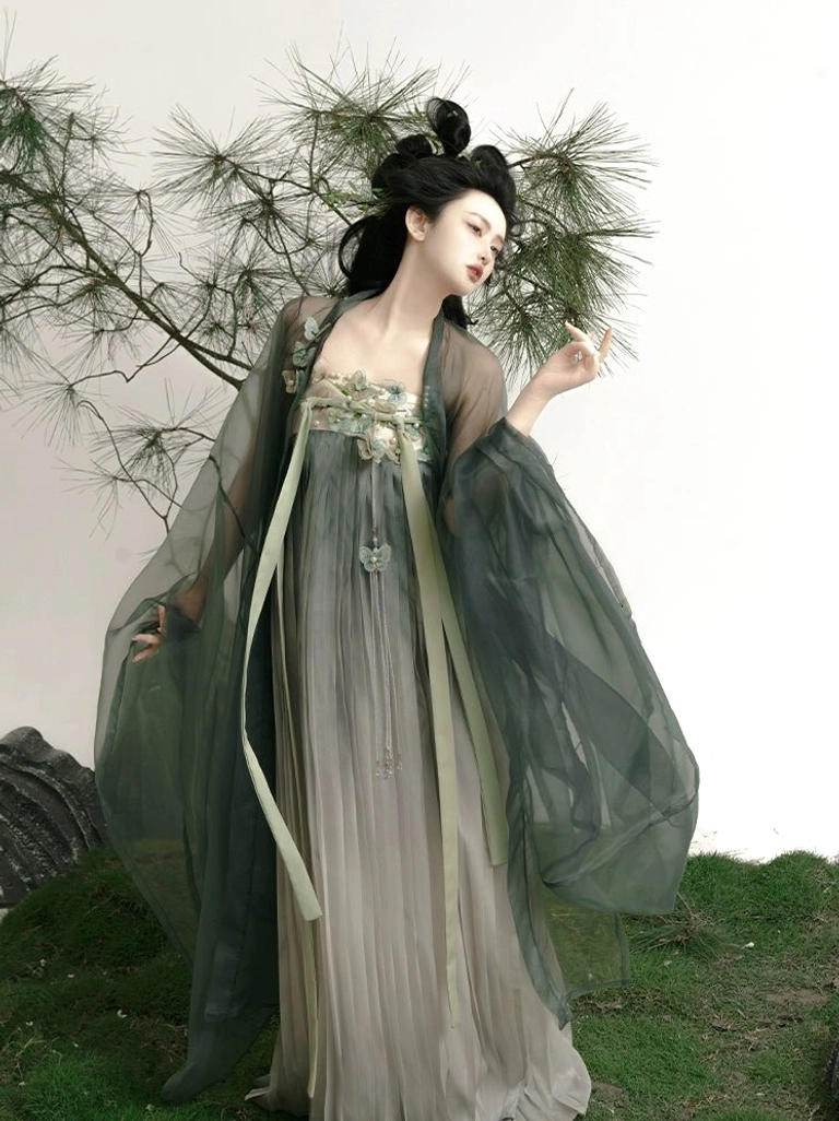 Three-quarter side view of Mountain Mist Tang Dynasty Hanfu Qixiong Ruqun with dark green sheer outer robe, gradient grey pleated skirt, floral chest embroidery, and flowing light green waist sashes