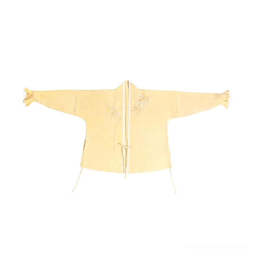 Flat lay of mustard yellow Song Dynasty Hanfu winged sleeve top with cross collar, tie fasteners, chest embroidery, and ruffled sleeve edges