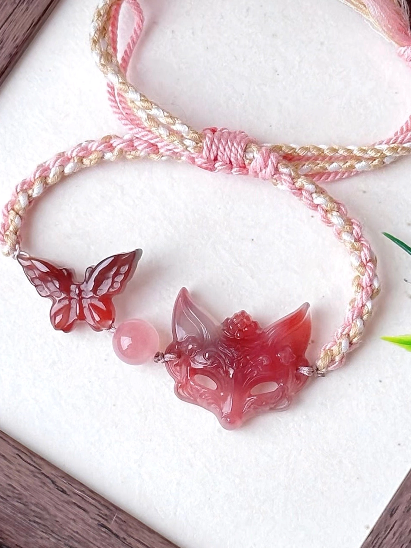 Front view of natural agate fox spirit Chinese bracelet with carved fox pendant matching agate butterfly polished bead and hand-braided Chinese cord