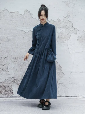 Full-length front view of a navy blue modern Hanfu cheongsam maxi dress with long sleeves, Mandarin collar, frog fasteners, gathered waist, and soft corduroy-look texture