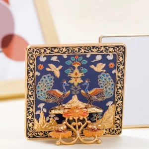 Navy blue peacock garden Chinese folding table mirror shown from the front, featuring a gilded scrolling frame, raised peacock and bird motifs, flowers, and traditional Chinese landscape details