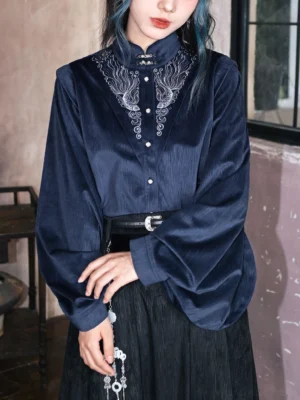 Close up of dark navy embroidered modern Hanfu shirt with silver phoenix cloud collar embroidery pearl button closure and ribbed velvet-like fabric