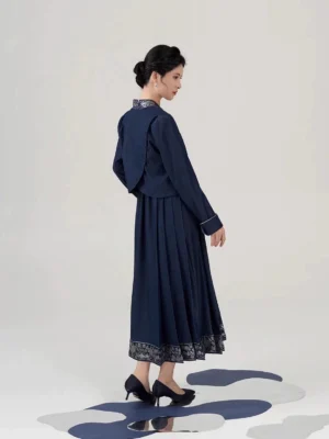 Back view of navy New Chinese Style peony embroidered cropped jacket and pleated mamianqun inspired midi dress set