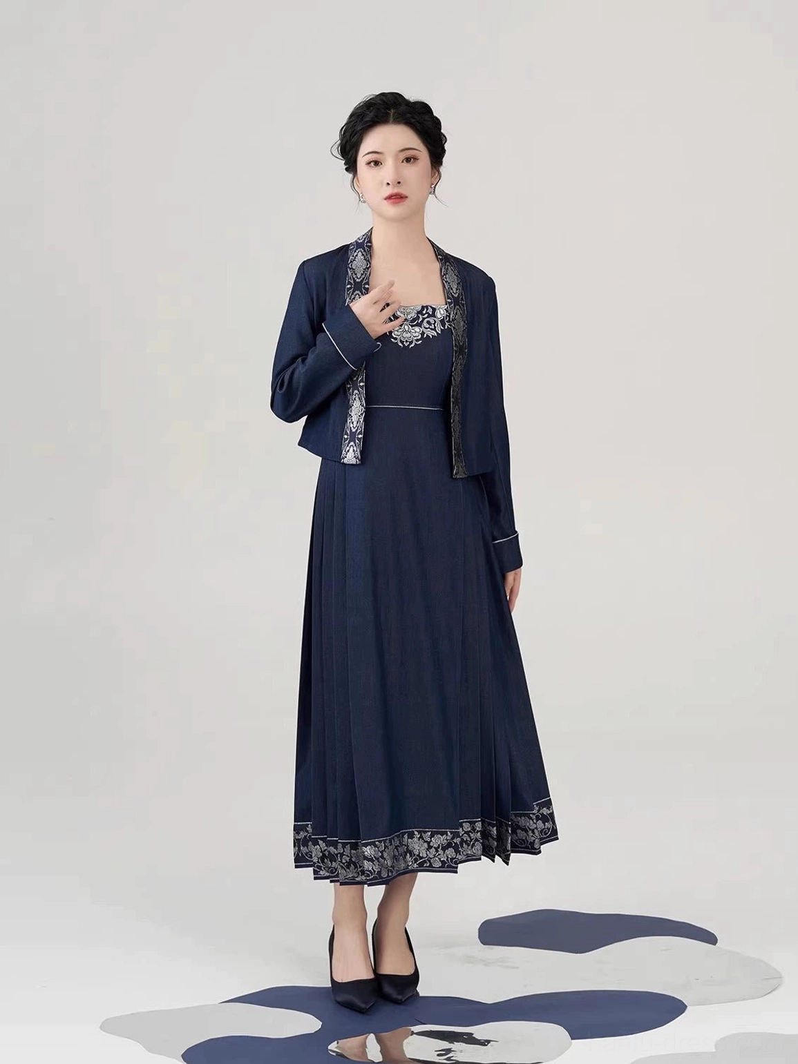 Model wearing navy peony embroidered New Chinese Style cropped jacket and pleated mamianqun inspired slip dress