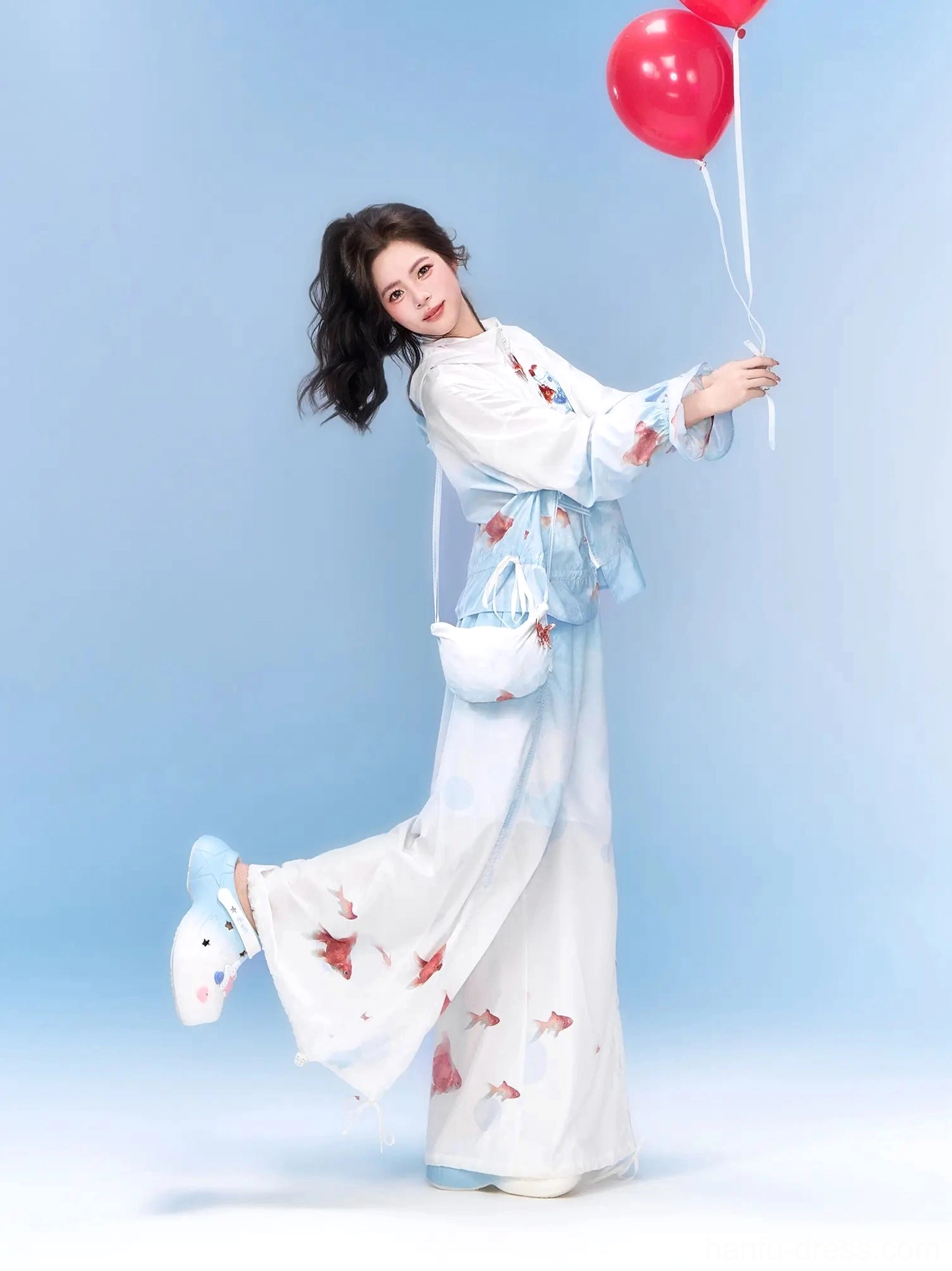 Neo-Chinese goldfish print hooded jacket and matching wide-leg trousers styled as a playful coordinated outfit with gradient blue fabric
