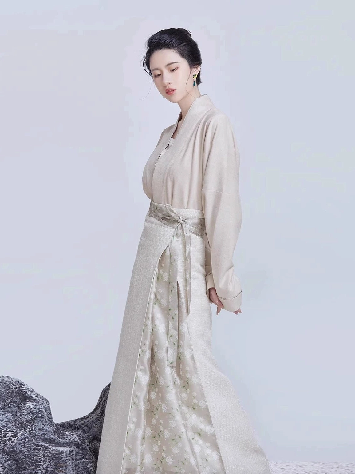 Neutral beige Song Dynasty Hanfu outfit with cross-collar inner top, jacquard three-pleat skirt, matching waist sash, and elegant minimalist silhouette
