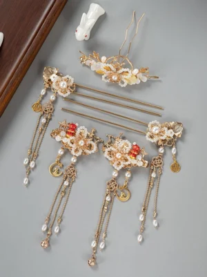 Complete New Year Hanfu hair accessories set with gold-toned hair clips hairpins decorative crown faux pearls red floral accents and long Chinese tassel pendants arranged on a grey studio background