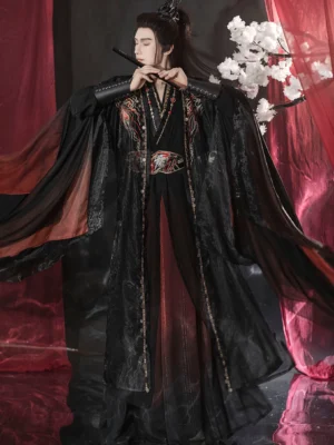 Close front view of male Chinese fantasy hanfu costume with black flute, layered red robe, metallic trims, and dark fire embroidery