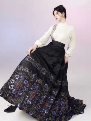 White stand collar Hanfu blouse paired with a flowing black mamianqun horse face skirt with colorful floral brocade hem