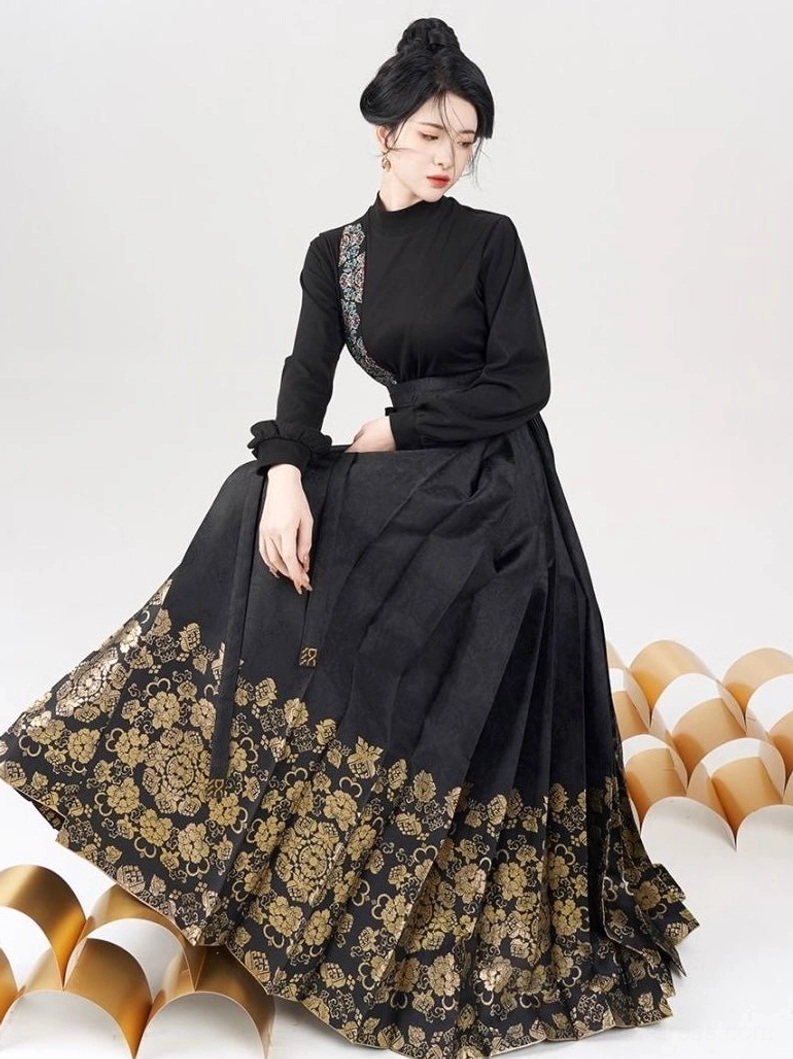 White traditional Chinese stand collar blouse with black floor length mamianqun skirt and gold floral brocade hem