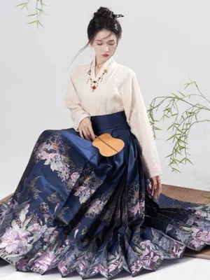 Night Orchid Ming-inspired Hanfu Mamianqun horse face skirt in navy blue with purple orchid print shown in a seated studio outfit