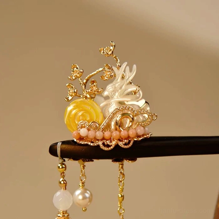 Front view of nine-tailed fox Chinese hair stick with shell fox centerpiece, gold floral filigree, yellow shell ornament, pearl tassels and bead chains
