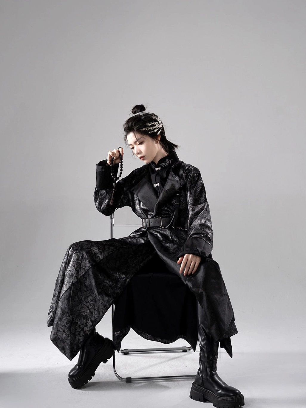 Side seated view of Nocturne dark wuxia hanfu robe with long flowing Tang style silhouette, black jacquard fabric, and waist belt