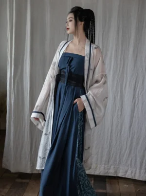 Side profile of a woman wearing the Observing Mist Song Dynasty Hanfu outfit with flowing off-white outer jacket and navy wide-leg lower layer