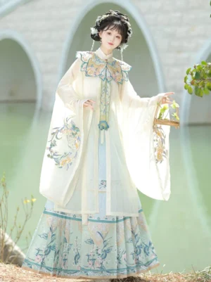 Off-white and light blue Ming Dynasty Hanfu outfit with embroidered robe and mamian skirt styled beside a stone arch bridge with a traditional Chinese hair ornament