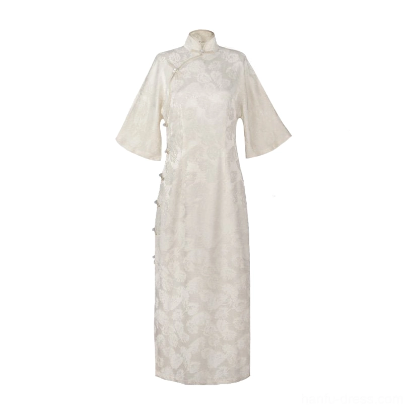 Flat lay of an off-white modern qipao dress with subtle floral jacquard fabric, stand collar, hidden side frog buttons, and full-length traditional silhouette
