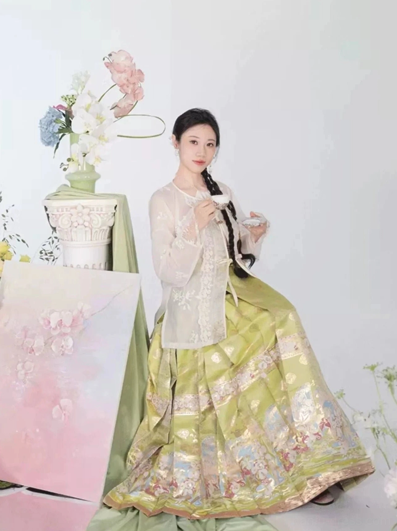 Olive green modern Hanfu mamian skirt styled with a sheer embroidered white outer blouse and gilded floral patterns