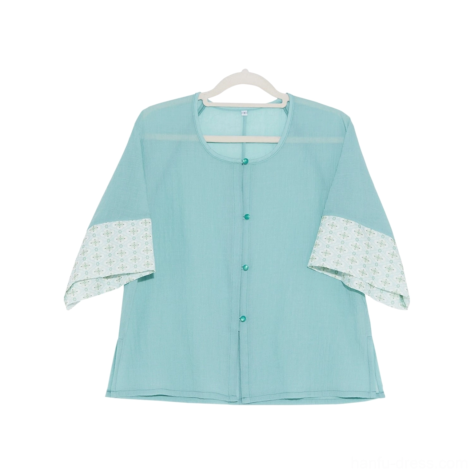 Light cyan cropped modern Hanfu blouse flat lay with round neckline front buttons and patterned three quarter sleeves