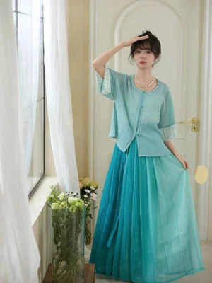 Only Green Ming Dynasty inspired modern Hanfu outfit with light cyan cropped blouse and teal gradient pleated skirt front three quarter view