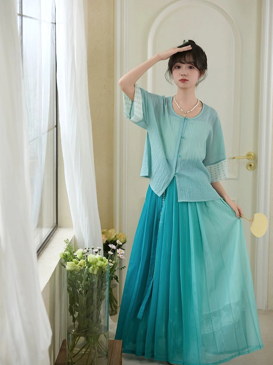 Only Green Ming Dynasty inspired modern Hanfu outfit with light cyan cropped blouse and teal gradient pleated skirt front three quarter view