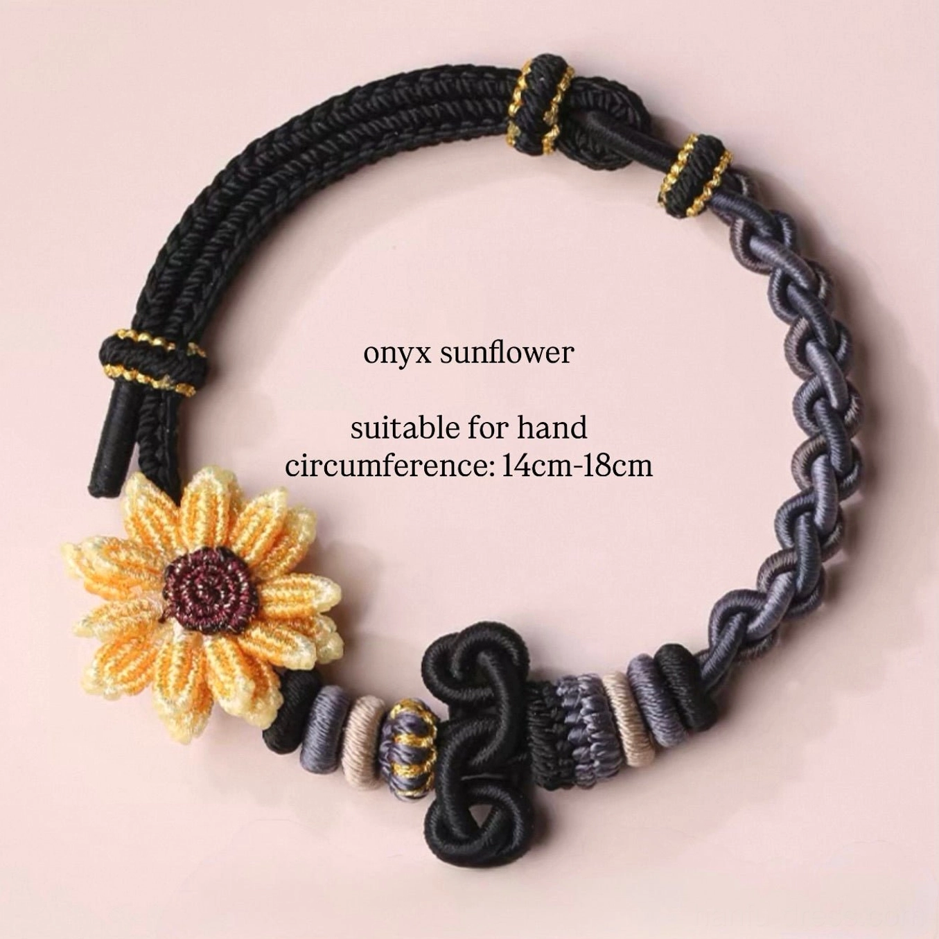Onyx sunflower handwoven Chinese knot adjustable bracelet with black and grey purple woven cords, gold thread knot accents, and sunflower ornament on a light pink background
