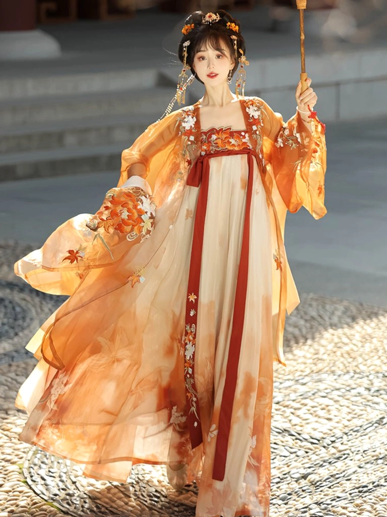 Side front view of orange Tang Dynasty Hanfu Heziqun dress featuring watercolor-style skirt print, embroidered sash trim, and flowing historical costume silhouette