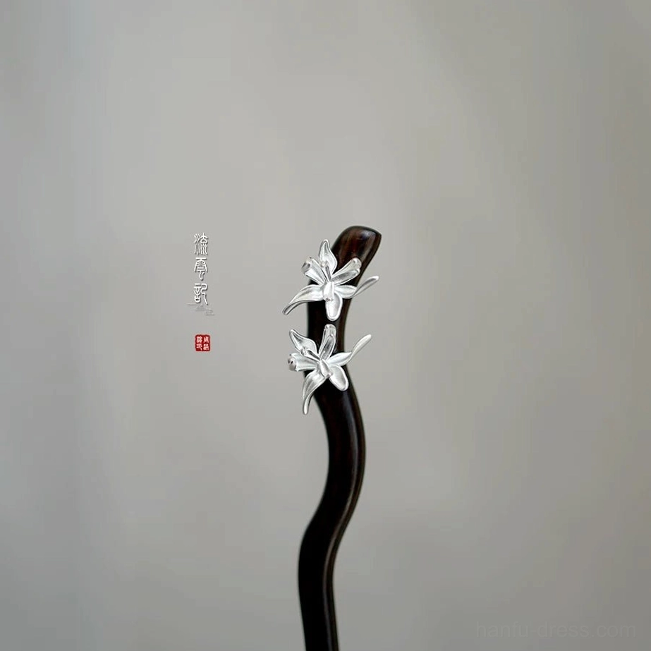 Traditional Chinese hair stick with curved dark wooden shaft and paired silver orchid flowers on a light gray background