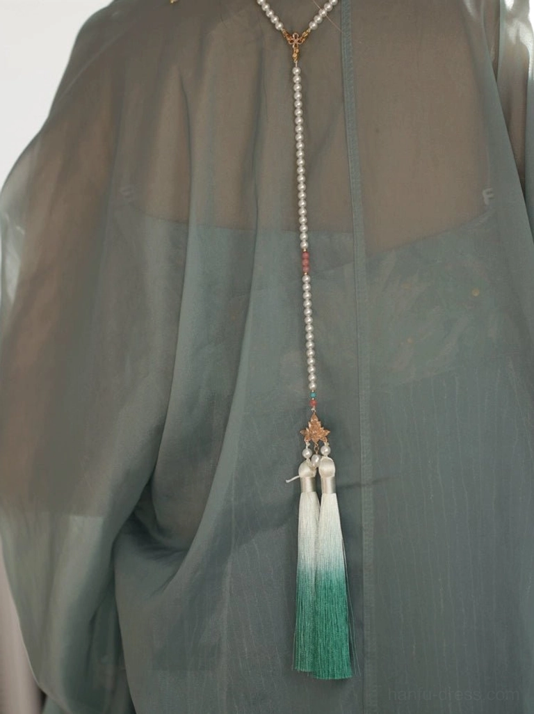 Back view of orchid Hanfu necklace on grey traditional clothing showing pearl chain, maple leaf charm and long green tassels