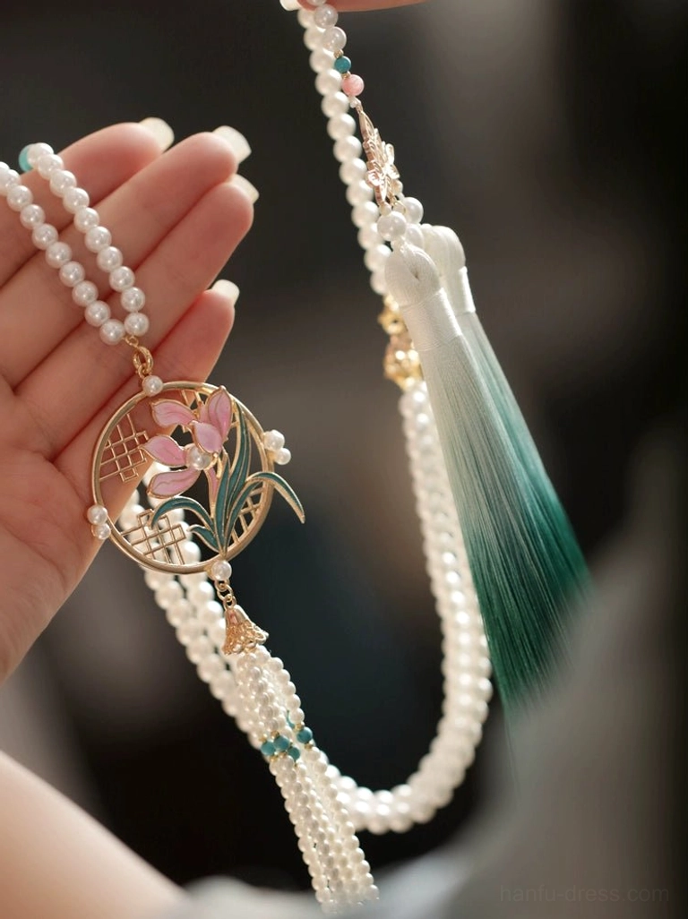 Full view of orchid pendant Hanfu necklace with double pearl chains, circular floral medallion and layered green tassel decoration