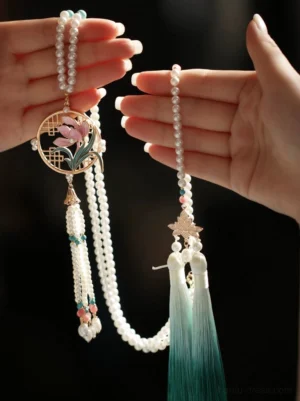 Handheld orchid Chinese style long necklace with pearl strands, maple leaf charm, pink floral details and gradient green tassels