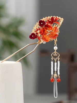 Oriental flame fan Chinese hair stick with red orange flowers pearl bead tassels and clear teardrop pendant displayed on white stand