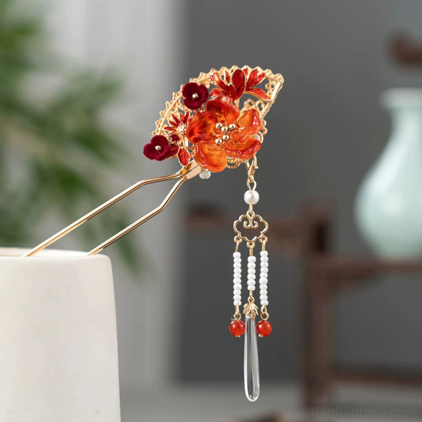 Right angled product view of oriental flame fan Chinese hair stick with gold tone filigree flowers red beads and tassel pendant