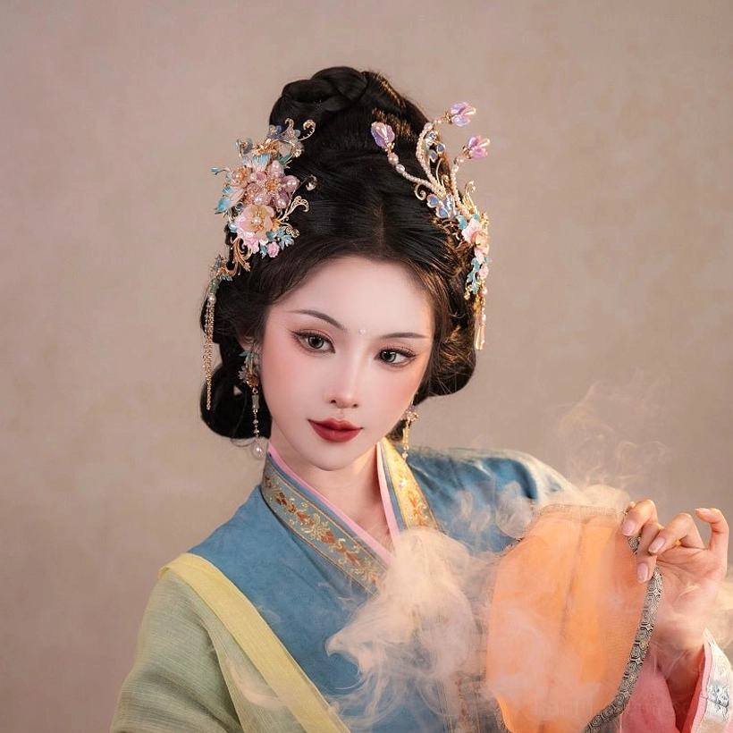Front portrait of a model wearing ornate Chinese Hanfu hair accessories with purple and blue floral accents and matching drop earrings