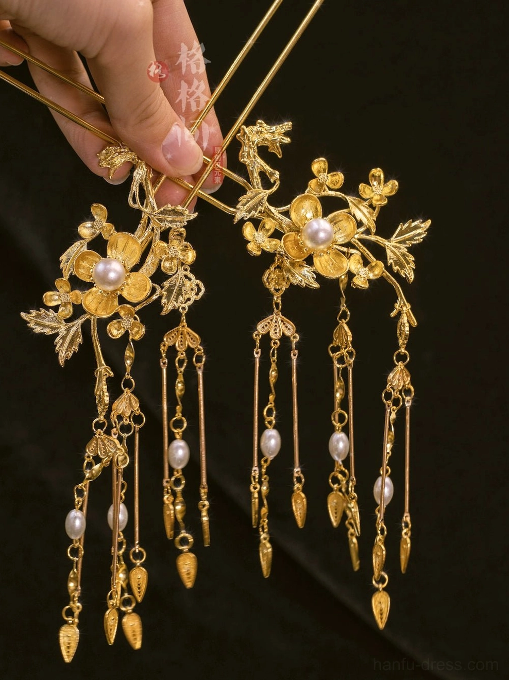Ornate gold-tone Chinese hair pins with intricate filigree flowers, embedded white pearls, pearl chains, and drop charms