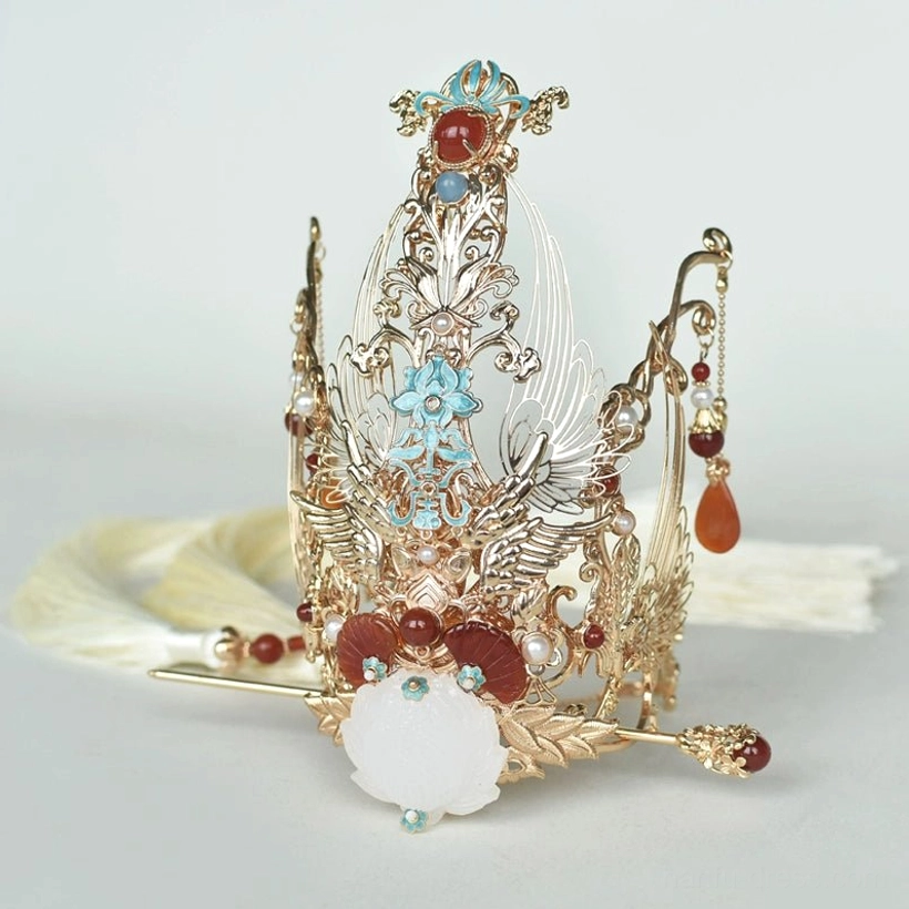 Front three-quarter view of a traditional Hanfu hair crown featuring symmetrical gold carving central blue enamel-style ornament white jade-like decoration and waterdrop pendants