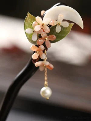 Top view of osmanthus floral crescent moon Chinese hair stick with wood-toned shaft and pearl tassel for Hanfu