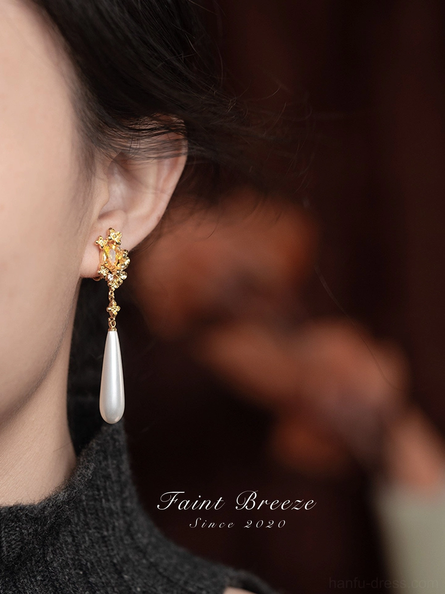 Woman wearing osmanthus pearl drop Chinese earrings, showing the elegant long dangling design for cheongsam and qipao styling