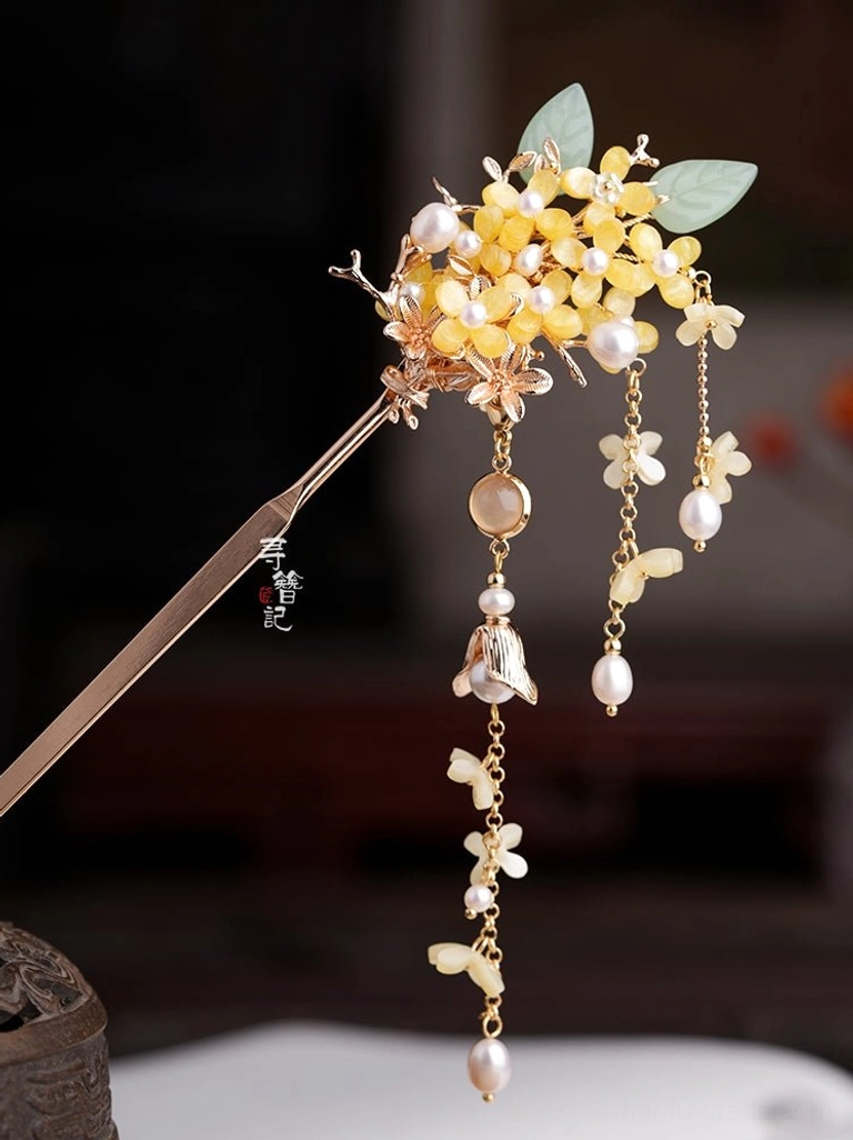 Pair of osmanthus pearl long tassel Hanfu hairpins with antique gold tone flowers jade-style green leaves and dangling floral pendants on a dark background