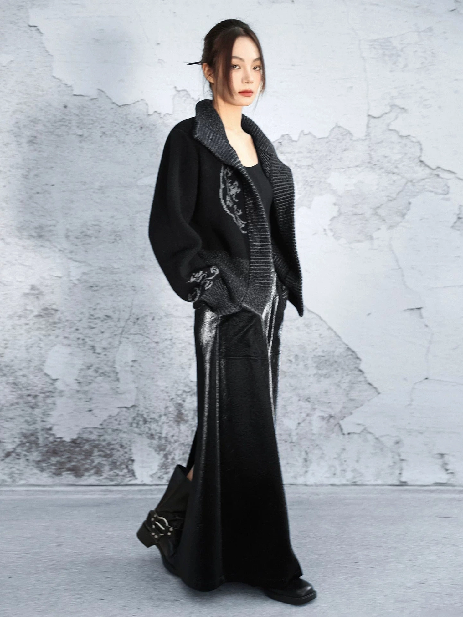 Oversized black Modern Hanfu knit cardigan with shawl collar and chest motif styled with a long black maxi skirt