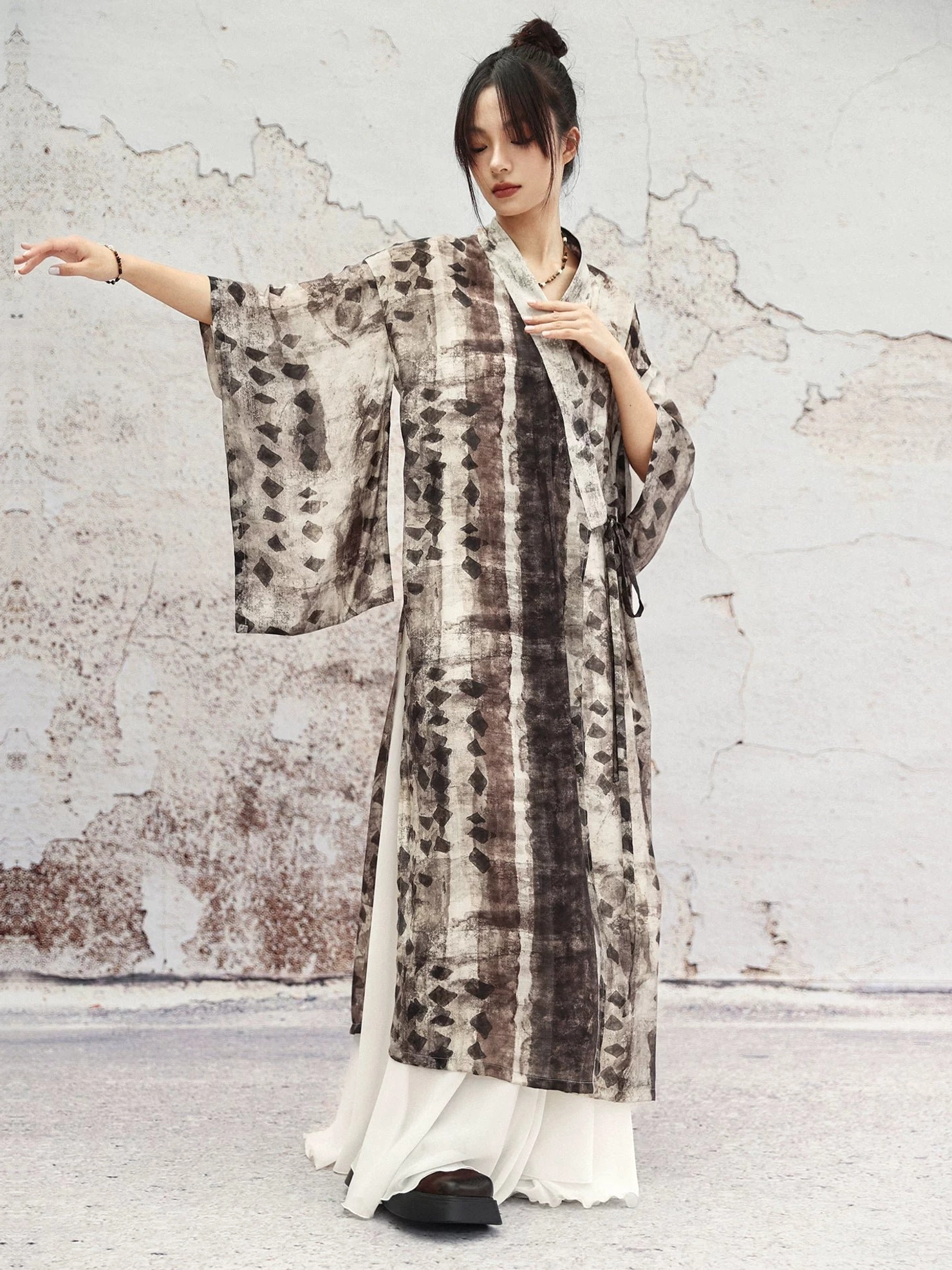 Side view of oversized modern Chinese style long cardigan featuring wide bell sleeves, loose fit, flowing hem, and side split