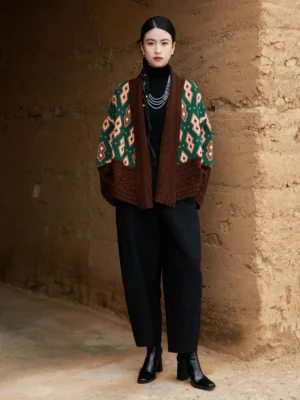 Front view of oversized modern Hanfu wool cardigan jacket with green orange geometric pattern brown shawl collar cuffs and hem
