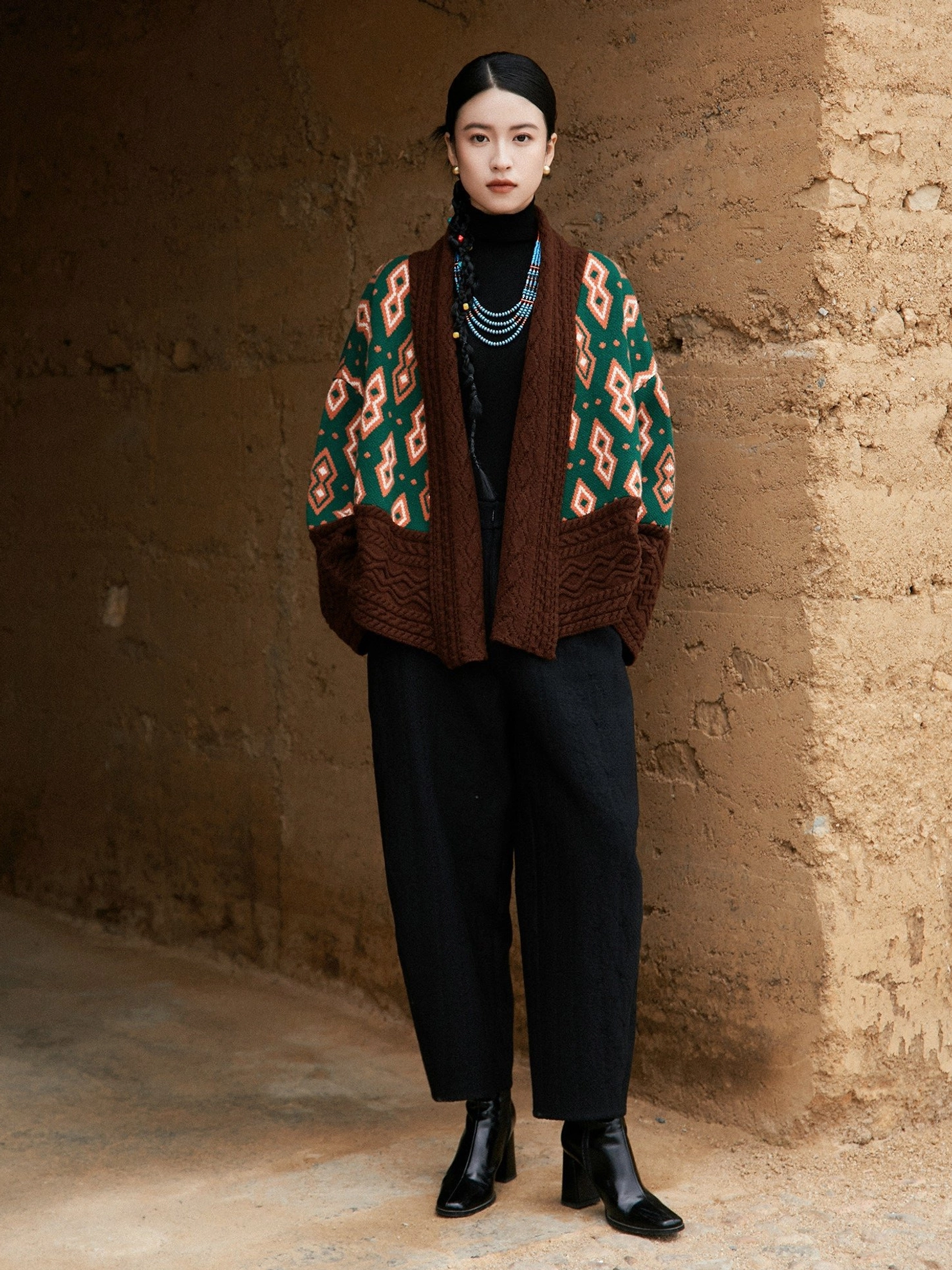 Front view of oversized modern Hanfu wool cardigan jacket with green orange geometric pattern brown shawl collar cuffs and hem