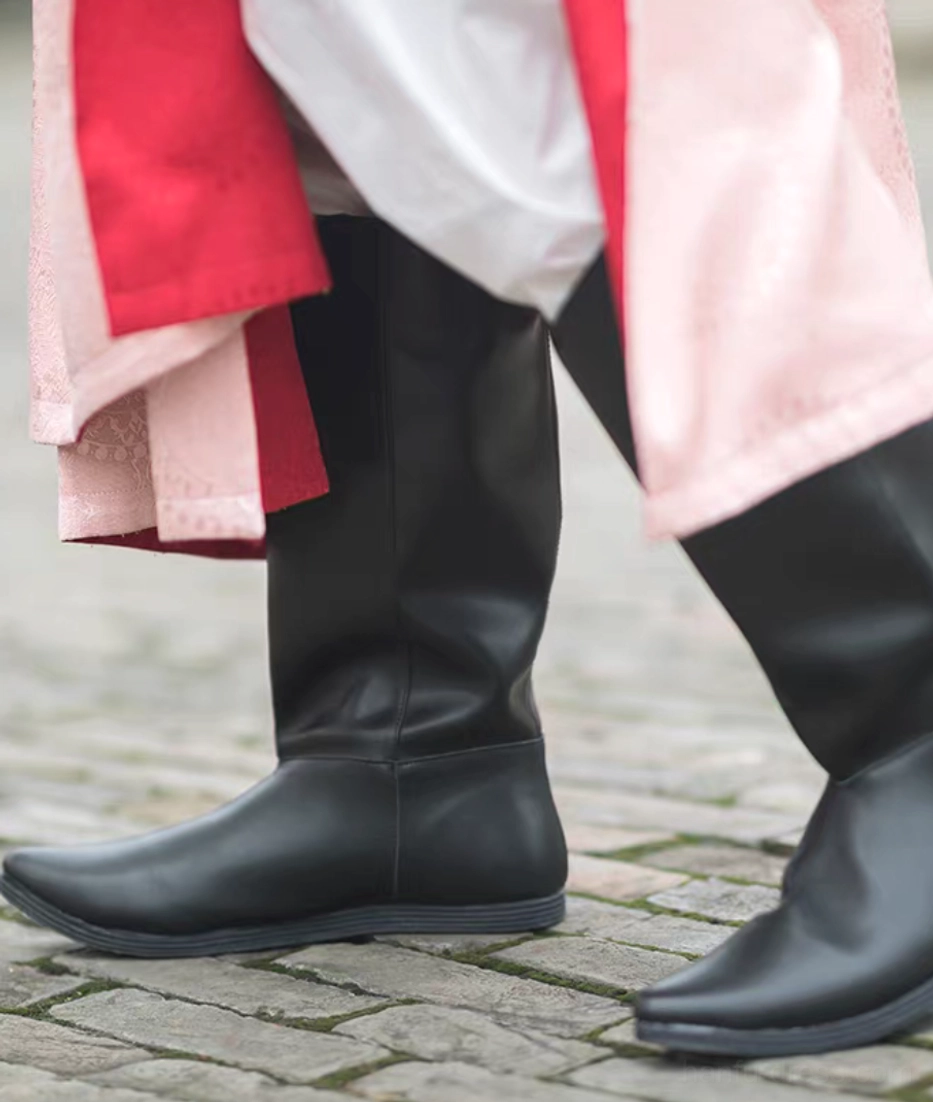 Front view of a pair of black men's traditional Chinese Hanfu boots with pointed flat toes, structured stitching, and flexible rubber soles
