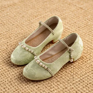 Pair of sage green traditional Chinese Hanfu shoes with floral jacquard uppers, round toes, pearl vamp trim, bow ankle straps, and low block heels