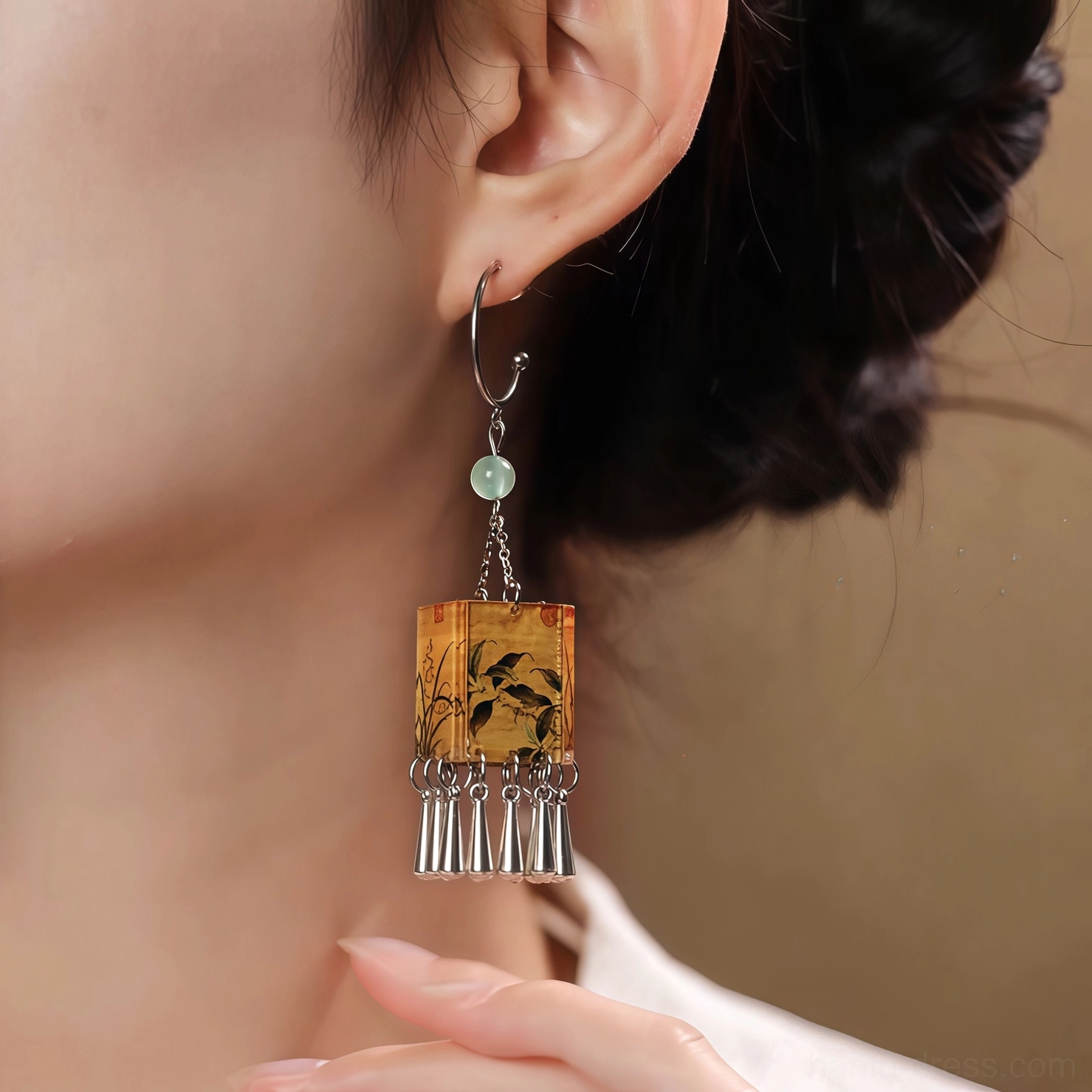 Woman wearing palace lantern orchid tassel Chinese earrings with a traditional Hanfu hairstyle