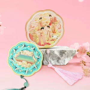 Palace Reverie Chinese hand mirror collection with pink court lady and turquoise crane palace designs, scalloped gold edges and matching tassels