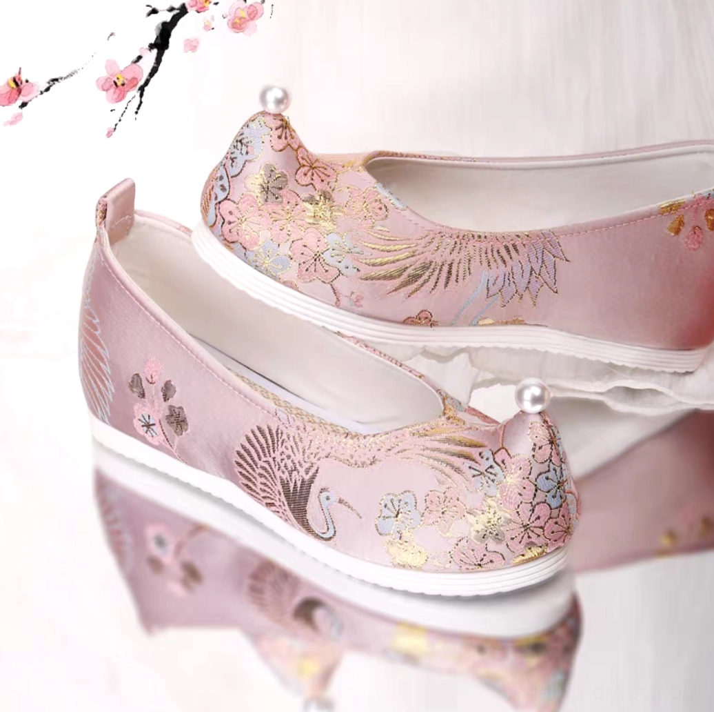 Pale pink upturned toe Chinese Hanfu shoes with crane and floral embroidery, pearl toe cap, and low white wedge rubber outsole