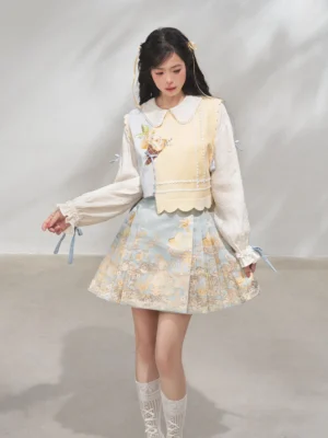 Pastel modern Hanfu three-piece outfit with yellow bijia vest, white blouse and light blue short mamian skirt front three-quarter view