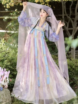 Front three quarter view of a woman wearing a pastel gradient Tang Dynasty Qixiong Ruqun Hanfu dress in a lush garden with embroidered sashes and flowing purple veil